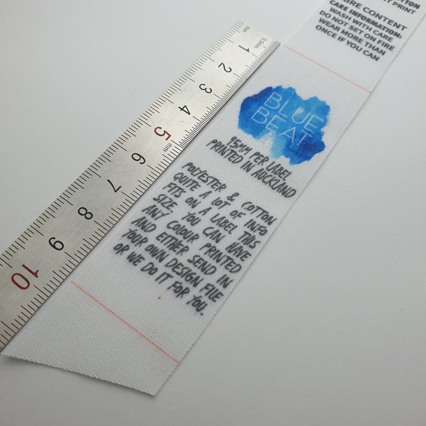 #03WPC - WHITE POLY/COTTON BLEND LABELS WITH LOGO &/OR INFO